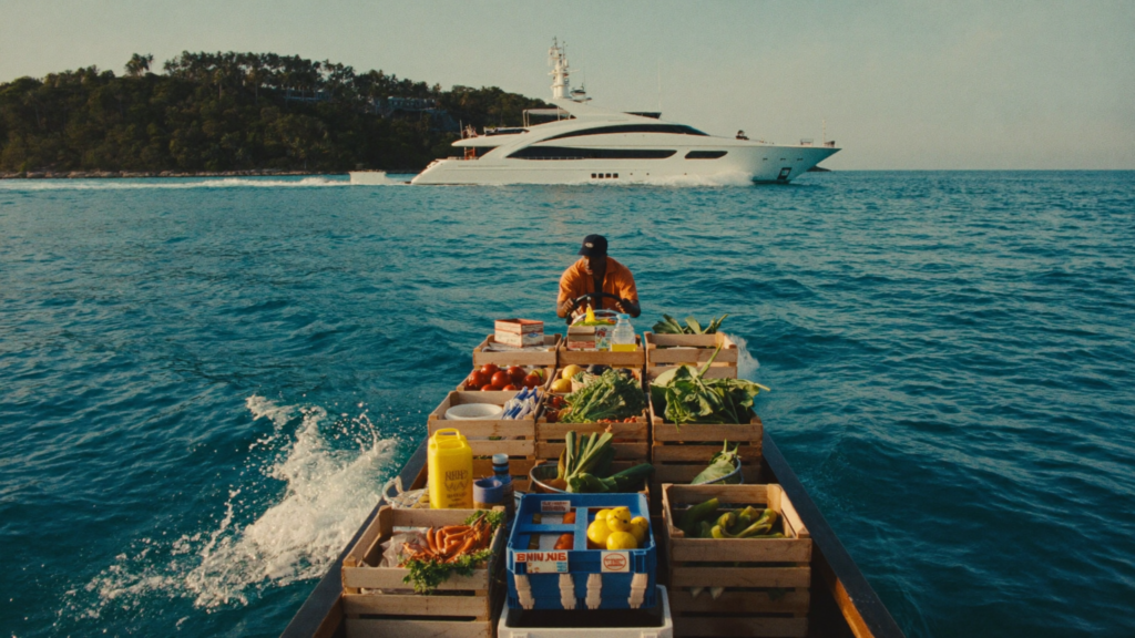 Tender loaded with provisions heading to a yacht anchored off a remote atoll