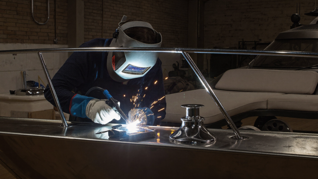 Marine fabricator TIG welding a stainless steel yacht railing