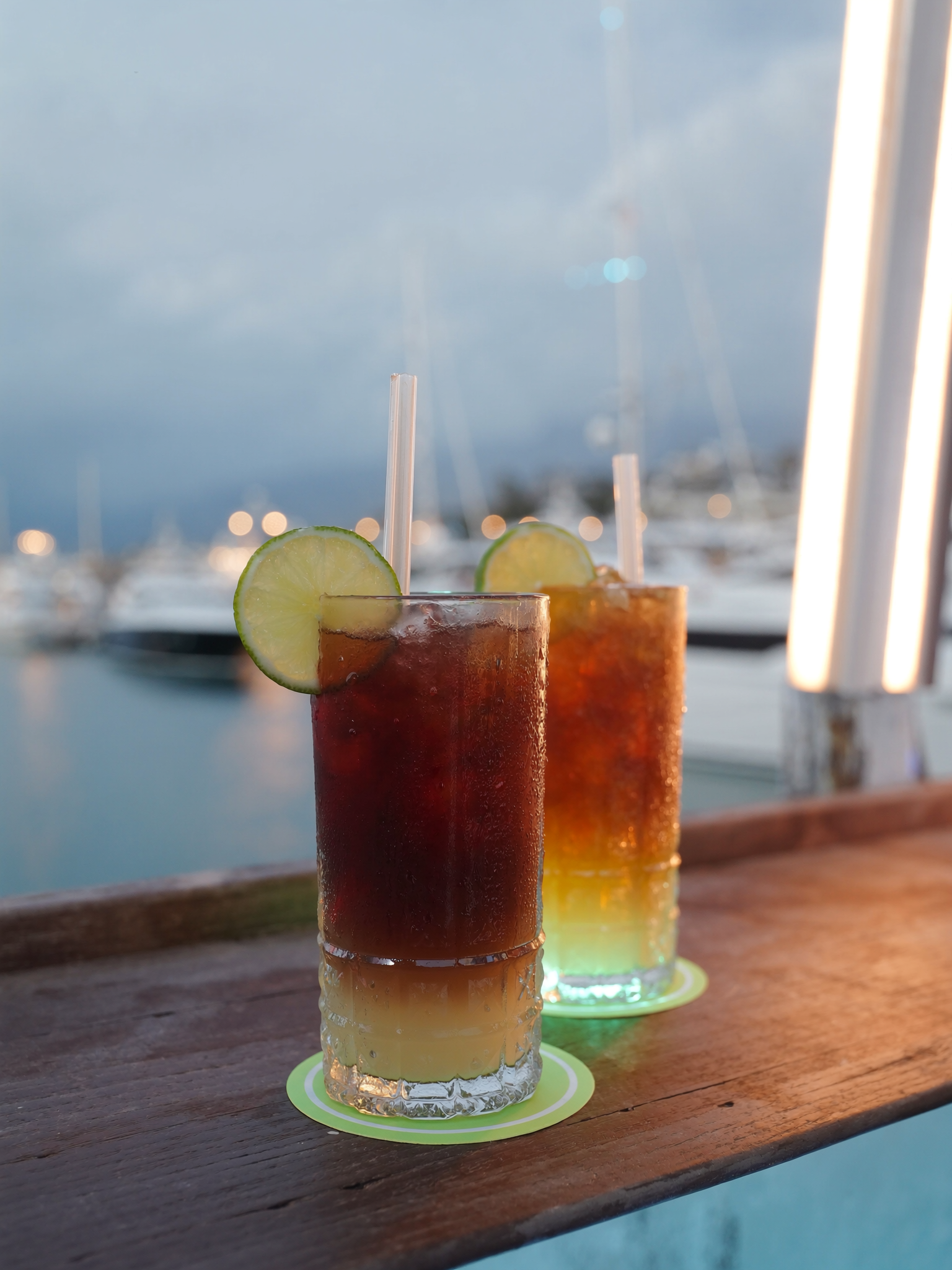 Dark and stormy cocktails at a marina bar at blue hour, FLIBS 2026