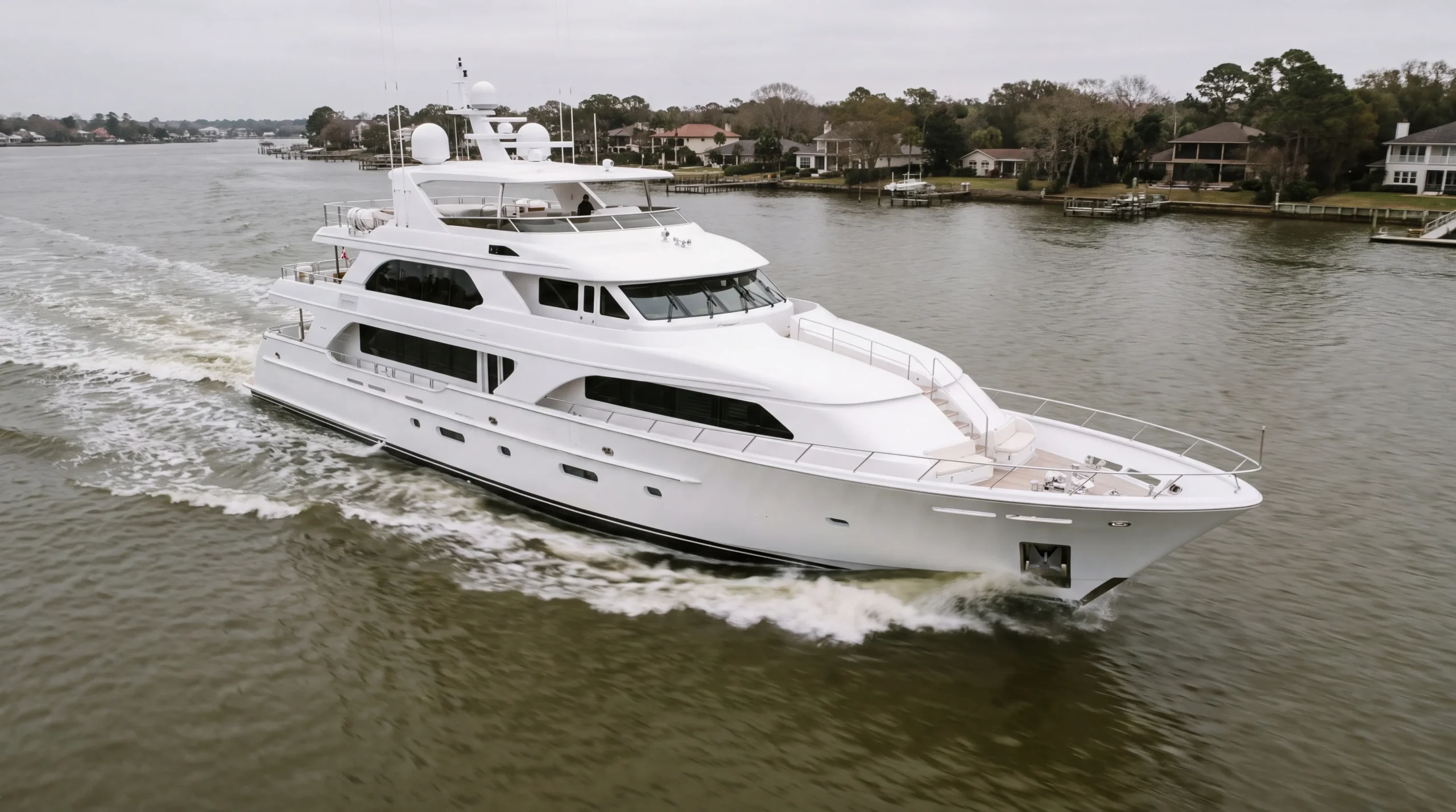 A 45-metre white motor yacht under way on the Fort Lauderdale Intracoastal at golden hour